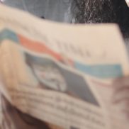 people looking at newspaper